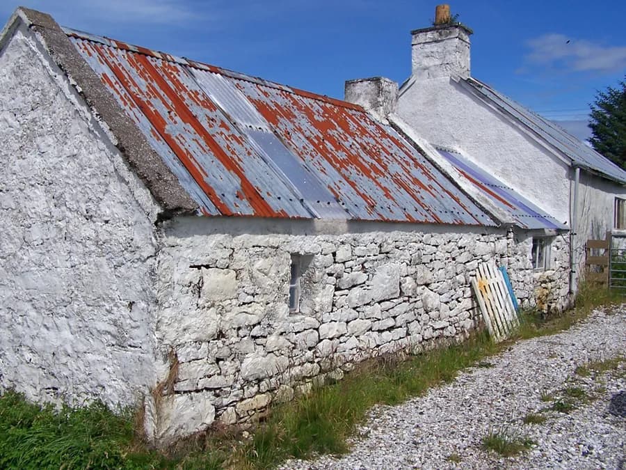 Un blanco muy magro sobre mampostería, isla de Skye: cada piedra se lee aún bajo la capa.